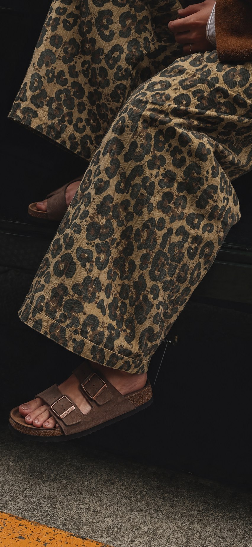 Wide leopard-print trousers styled with brown sandals