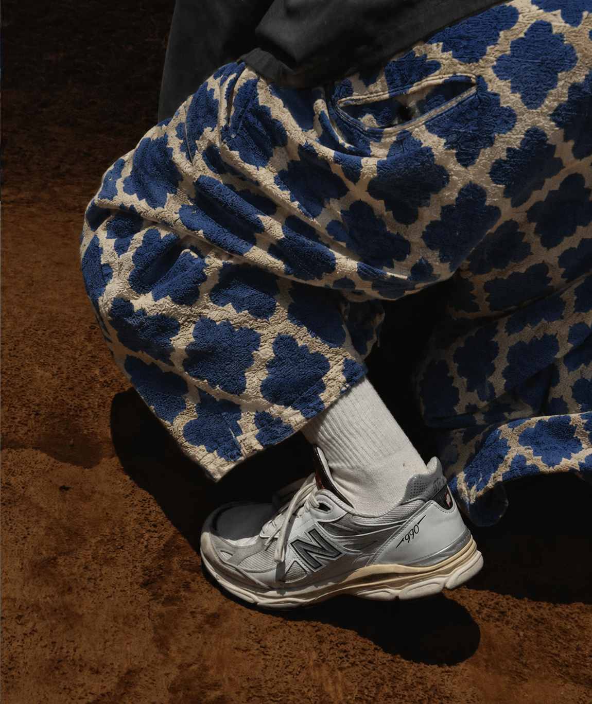 Textured blue leopard trousers styled with grey sneakers