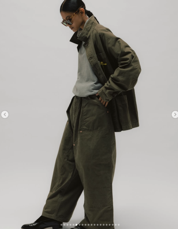 Olive oversized trousers shown mid-step