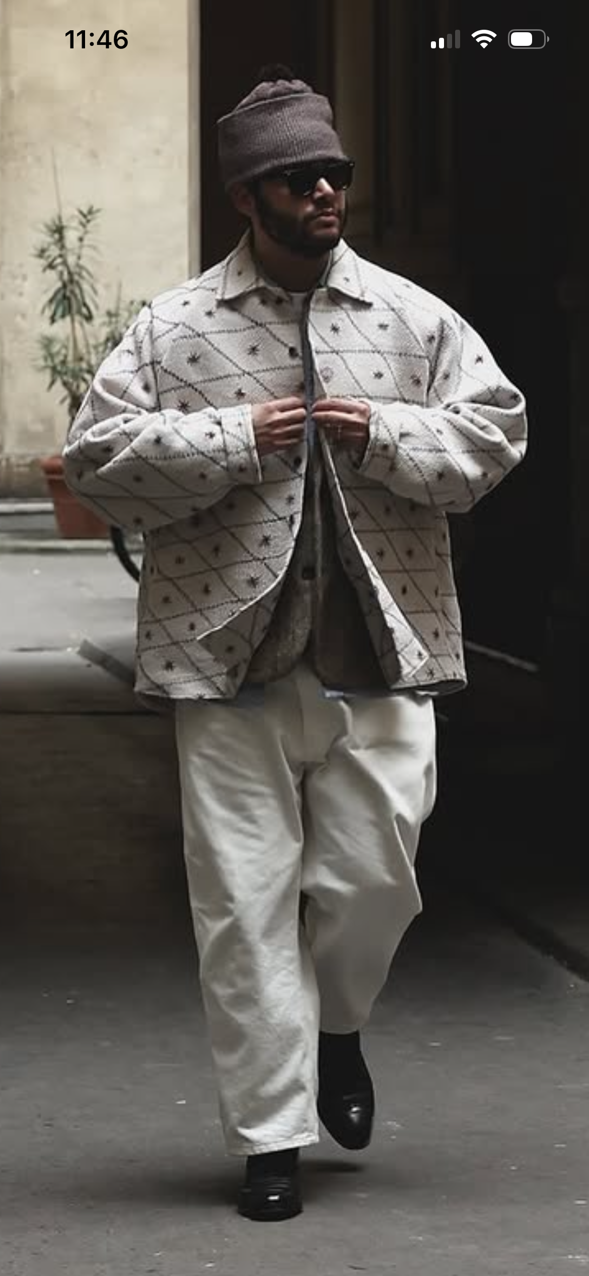 Oversized patterned jacket with relaxed cream trousers